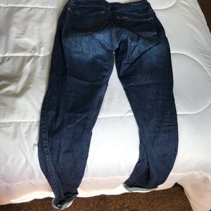 Dark denim jeans with holes distressed